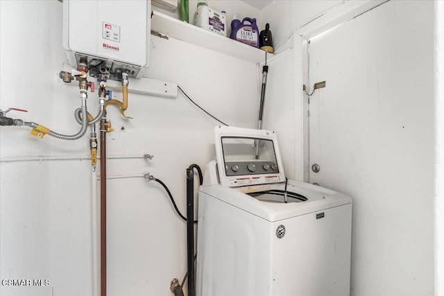 laundry area featuring water heater and washer / clothes dryer