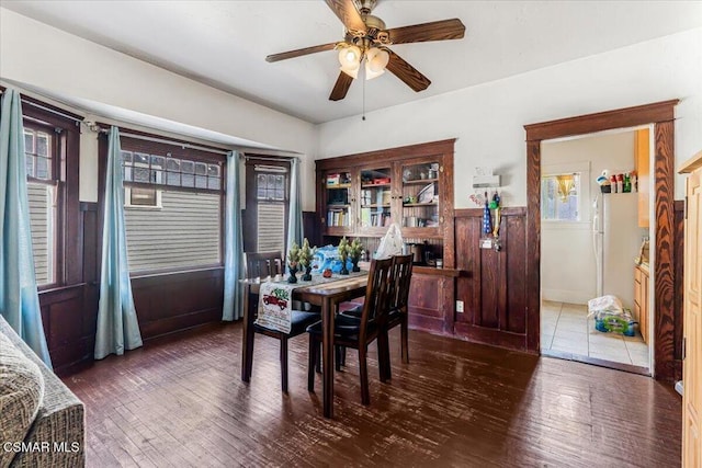 dining space with ceiling fan and dark hardwood / wood-style flooring