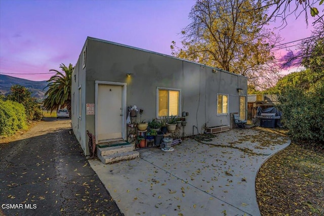 view of back house at dusk