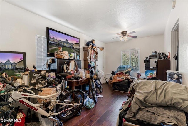 interior space with dark wood-type flooring, ceiling fan, and a textured ceiling