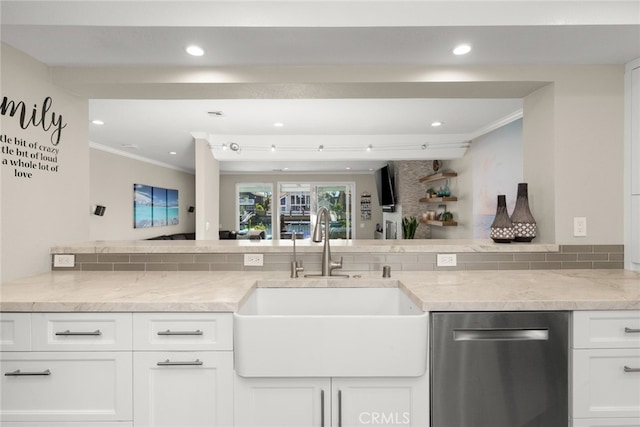 kitchen with white cabinetry, sink, light stone counters, and stainless steel dishwasher