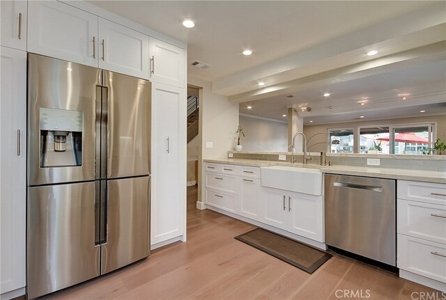 kitchen with white cabinetry, appliances with stainless steel finishes, and sink