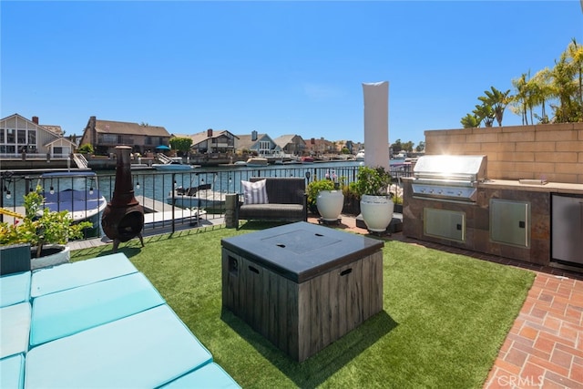 view of patio with a grill, a water view, and area for grilling