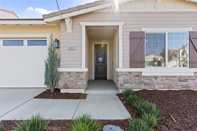 view of exterior entry with a garage