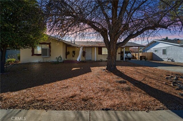 ranch-style home featuring a carport