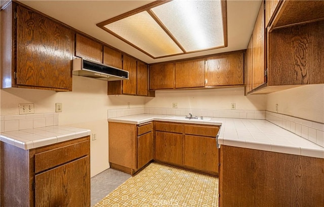 kitchen featuring sink and tile countertops