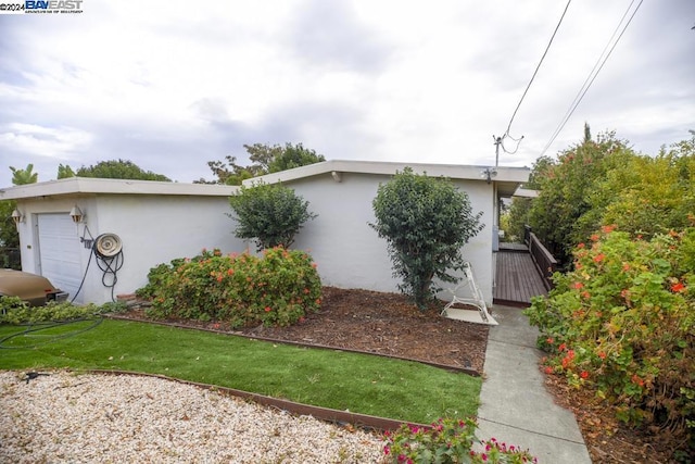 view of side of home featuring a garage