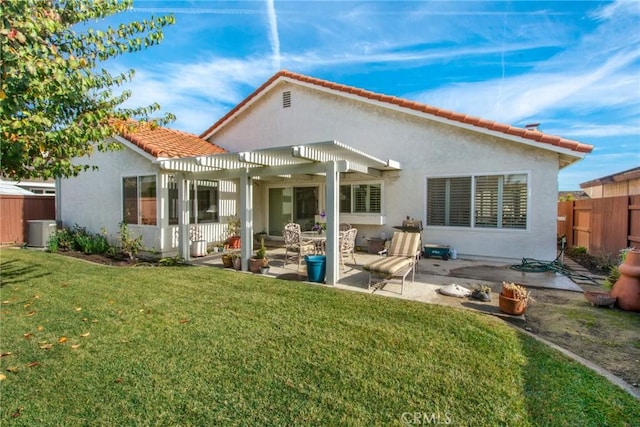 back of house with a yard, a pergola, and a patio