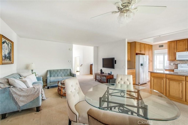 living room with ceiling fan and light carpet