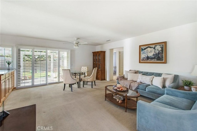 living room with ceiling fan and light colored carpet