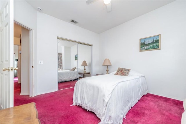 carpeted bedroom with ceiling fan and a closet