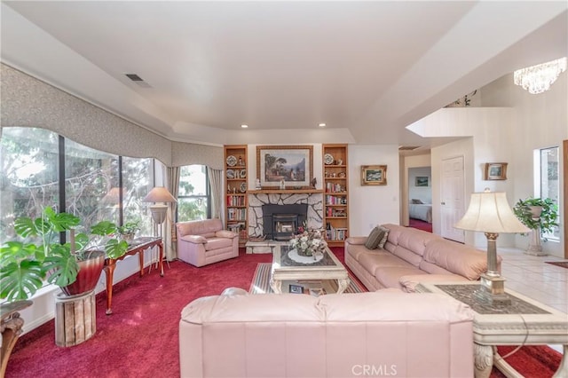 living room featuring carpet and a stone fireplace