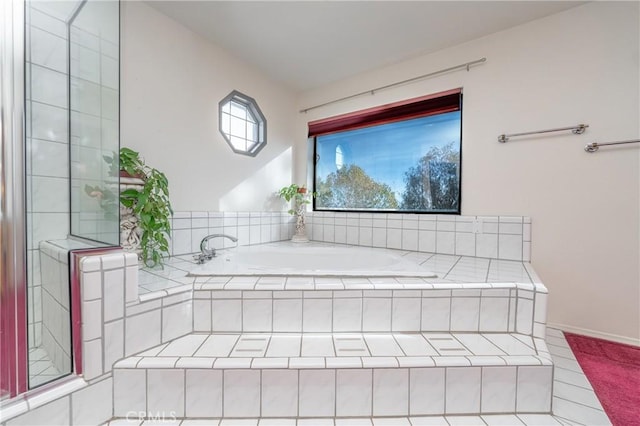 bathroom with a relaxing tiled tub