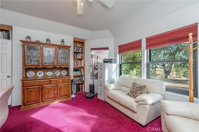 living area with carpet, ceiling fan, and plenty of natural light