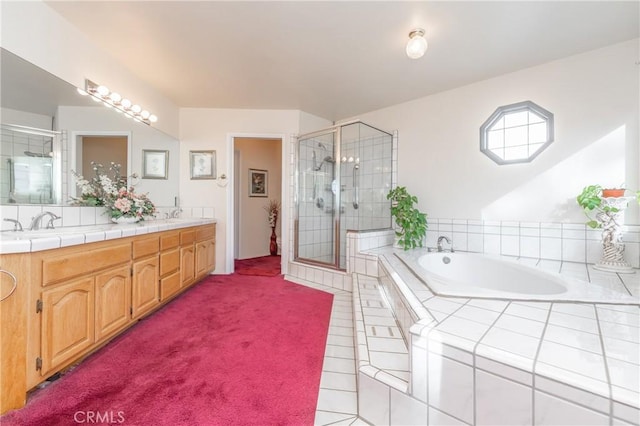 bathroom featuring shower with separate bathtub and vanity