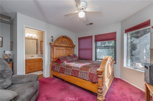 carpeted bedroom with ceiling fan and ensuite bath