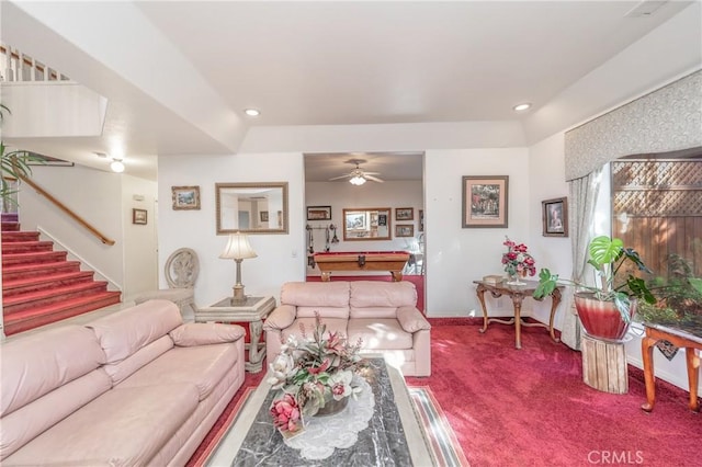 carpeted living room with ceiling fan and pool table