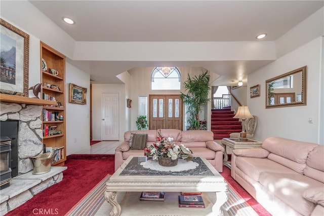 tiled living room featuring built in shelves and a wood stove