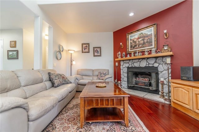 living room with a fireplace and light hardwood / wood-style flooring