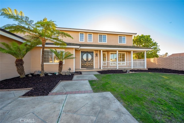 view of front of house with a front lawn and a porch