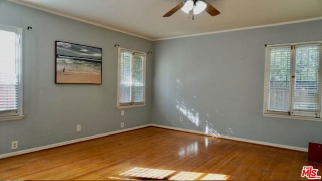 empty room featuring ceiling fan, ornamental molding, and hardwood / wood-style floors