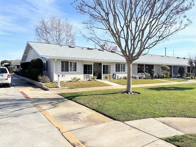 ranch-style home featuring a front yard