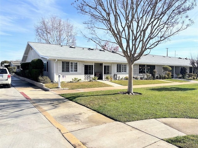 ranch-style home featuring a front yard