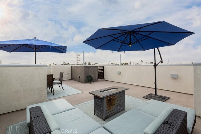 view of patio / terrace with an outdoor living space with a fire pit