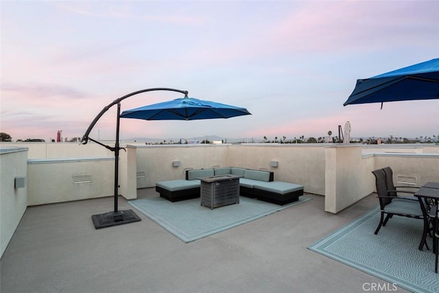 patio terrace at dusk with an outdoor hangout area