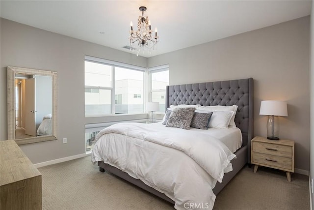 carpeted bedroom featuring an inviting chandelier