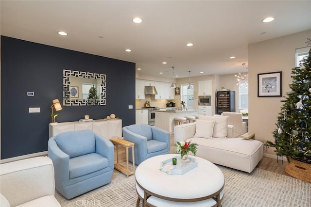 living room featuring a chandelier and light hardwood / wood-style floors