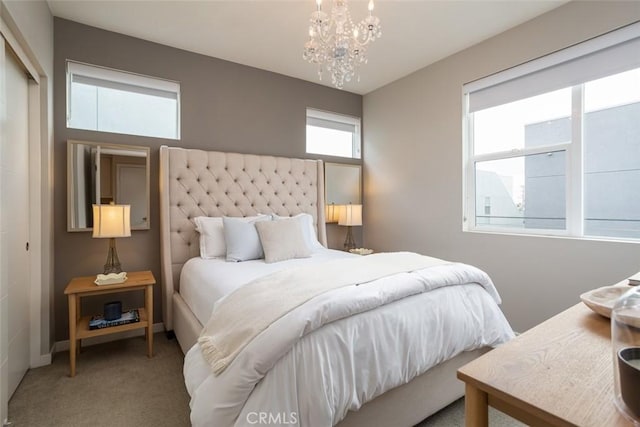 bedroom featuring carpet floors, a closet, and a chandelier