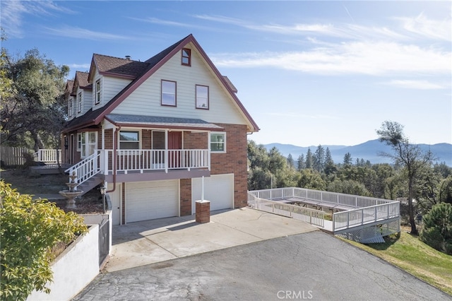 view of front of home with a mountain view, a garage, and covered porch