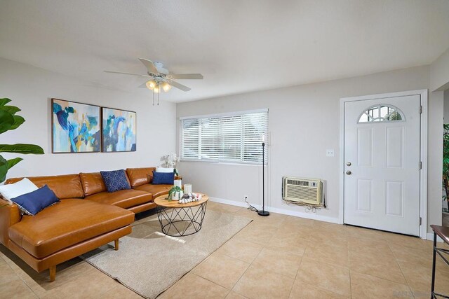 living room featuring light tile patterned floors, a wall unit AC, plenty of natural light, and ceiling fan