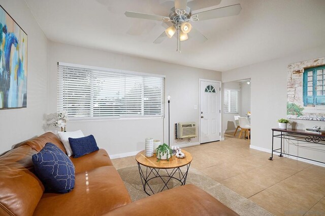 tiled living room with ceiling fan and a wall mounted air conditioner