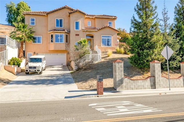 mediterranean / spanish-style house with a garage