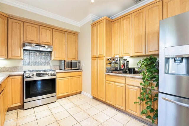 kitchen with light tile patterned floors, appliances with stainless steel finishes, and crown molding