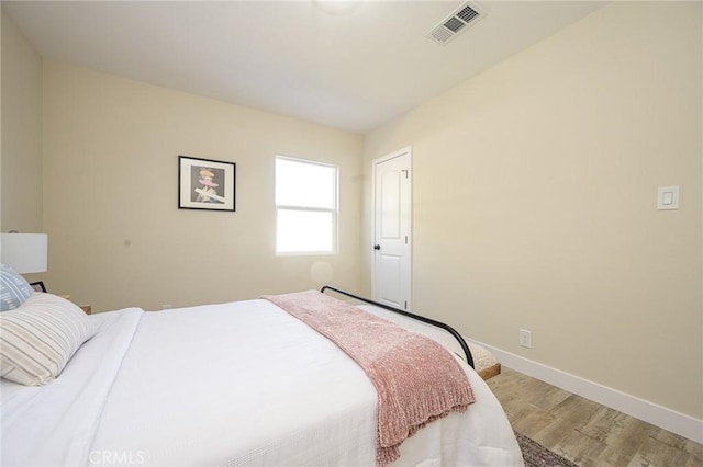 bedroom with wood-type flooring