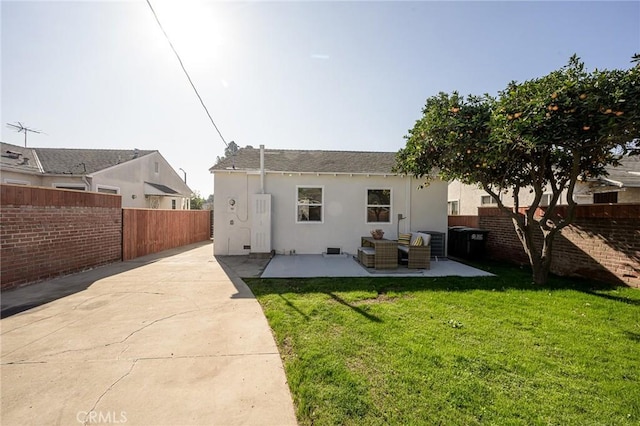 rear view of house featuring a patio area and a yard