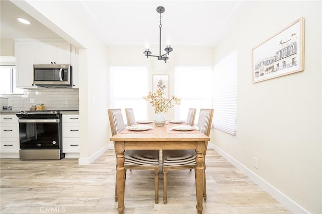 dining room featuring a chandelier and light wood-type flooring