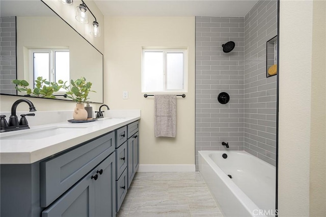 bathroom featuring tiled shower / bath combo and vanity