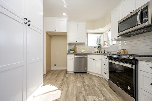 kitchen featuring white cabinetry and appliances with stainless steel finishes