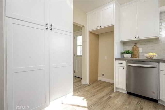 kitchen with stainless steel dishwasher, decorative backsplash, white cabinetry, and light hardwood / wood-style floors