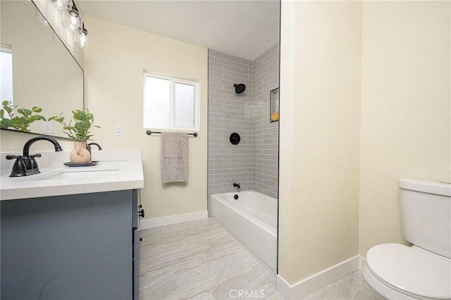 full bathroom with tiled shower / bath combo, vanity, and toilet