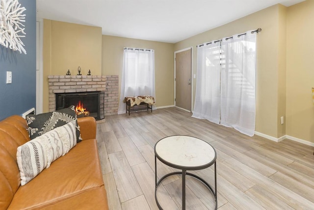 living room featuring hardwood / wood-style floors and a brick fireplace