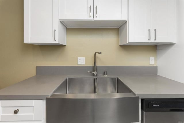 kitchen featuring white cabinets, dishwasher, and sink