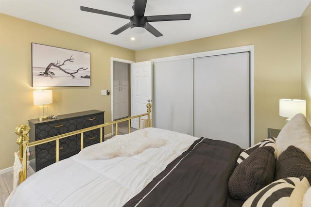 bedroom featuring ceiling fan, wood-type flooring, and a closet