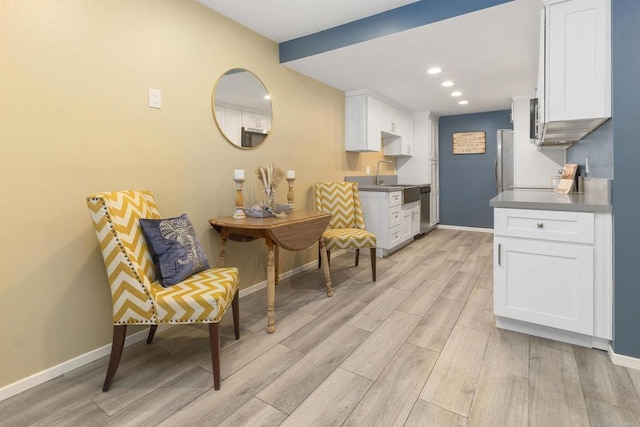 kitchen featuring white cabinets and sink