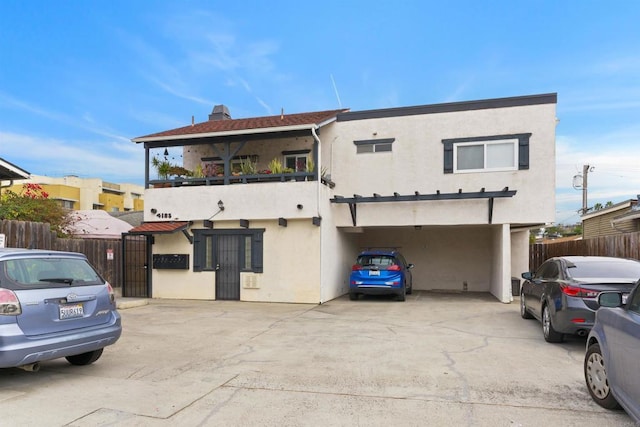 view of front of home with a garage and a balcony