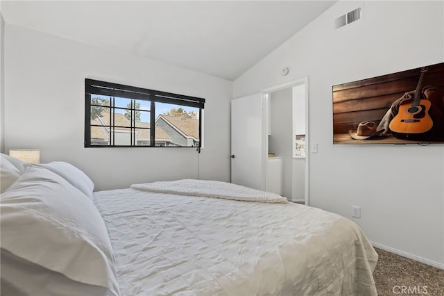 carpeted bedroom with vaulted ceiling